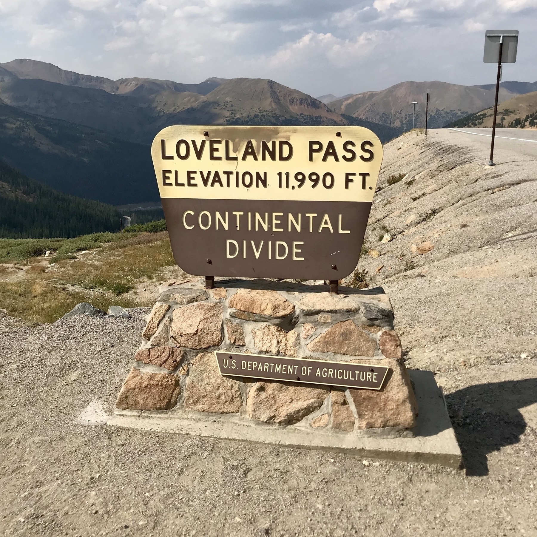 A vintage wood and stone sign from the US Department of Agriculture. Loveland Pass. Elevation 11,990 feet. Continental Divide.
